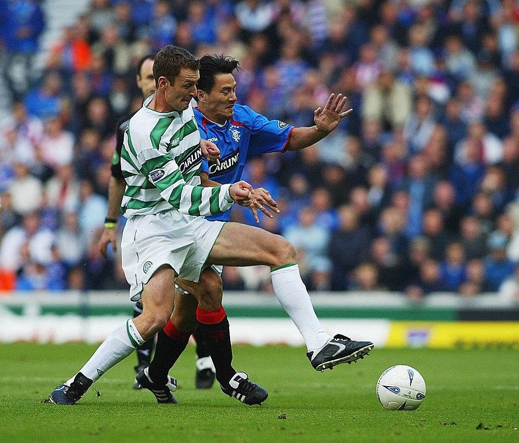 Michael Mols of Rangers gets tackled by Chris Sutton of Celtic