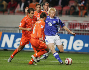 Aki Riihilahti of Finland and Rafael van der Vaart and Wesley Sneijder of Holland