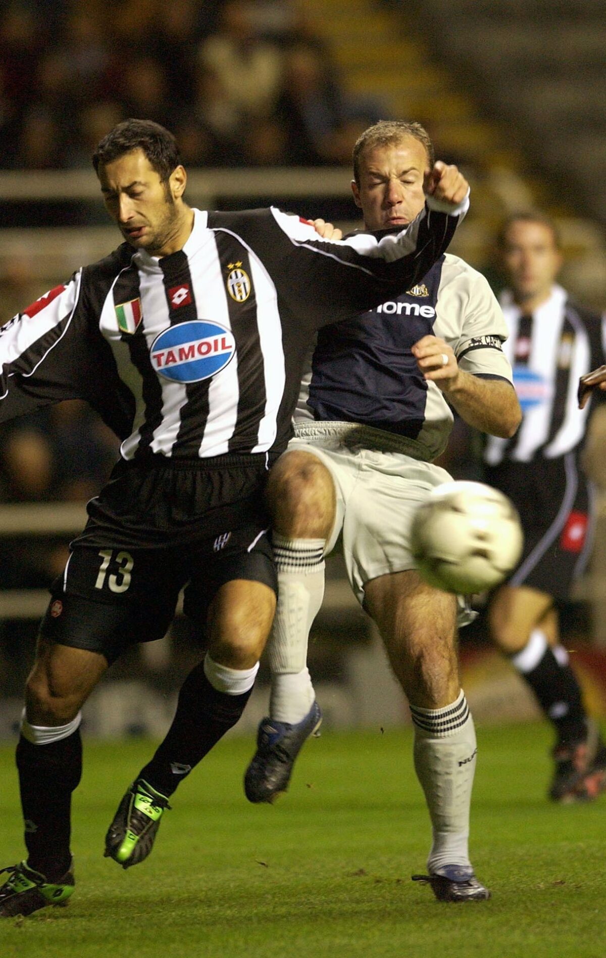 Alan Shearer of Newcastle challenges Mark Iuliano of Juventus